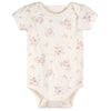 cache-couches bébé rose à manches courtes avec motifs floraux sur fond clair