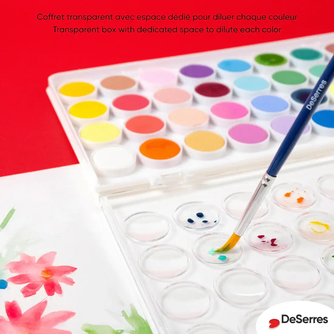 Palette aquarelle DeSerres 36 couleurs avec pinceau dans un coffret transparent sur fond coloré.