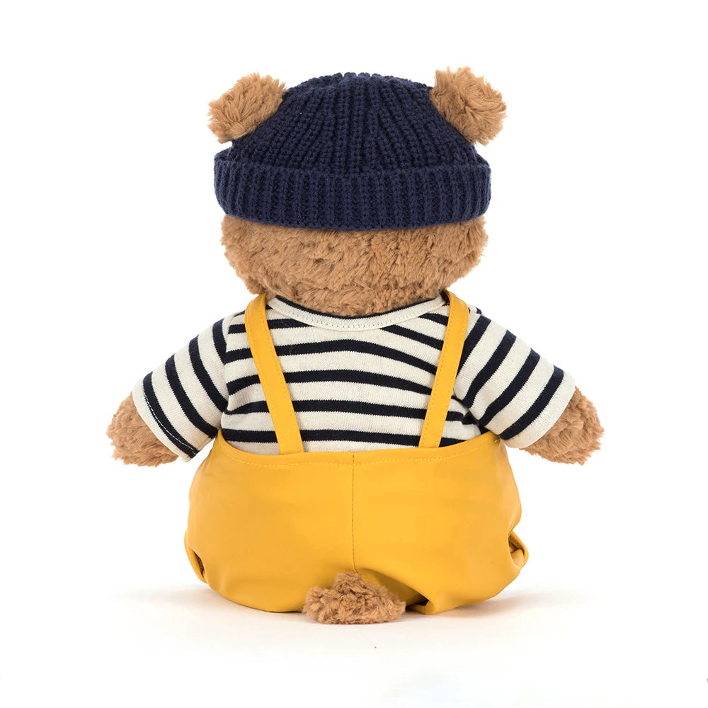 Jellycat Bartholomew Bear outfit avec chapeau bleu et salopette jaune, vue arrière.