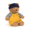 Mignon ours en peluche Jellycat Bartholomew Bear outfit avec un chapeau et une salopette jaune.