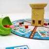 jeu coopératif Cakozaurus avec un monstre croque-gâteau et un plateau coloré.